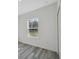 Bedroom featuring light grey wood floors, one window, white walls, and a door to closet at 15163 Sw 29Th Terrace Rd, Ocala, FL 34473
