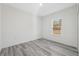 Bedroom featuring light grey wood floors, one window, and white walls at 15163 Sw 29Th Terrace Rd, Ocala, FL 34473