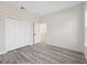 Bright, spacious bedroom with wood-look floors, closet doors, and an open doorway at 15163 Sw 29Th Terrace Rd, Ocala, FL 34473