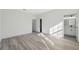 Bright bedroom with grey floors and a doorway to the bathroom on the right at 15163 Sw 29Th Terrace Rd, Ocala, FL 34473