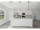 Bright, spacious kitchen featuring an island, modern appliances, and stylish pendant lighting at 15163 Sw 29Th Terrace Rd, Ocala, FL 34473