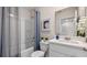 Bathroom with shower-tub, a vanity with solid surface top, framed mirror, and white toilet at 1948 Tamarack Pass, Davenport, FL 33837