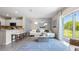 Cozy living room with tile floors, sofa, coffee table, decorative rug and curtains, and natural light at 1948 Tamarack Pass, Davenport, FL 33837