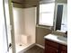 Bathroom featuring a white shower, vanity with dark wood cabinets, and a window at 1960 Fawn Meadow Cir, St Cloud, FL 34772