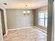 Bright dining room with wood-look floors and a classic chandelier fixture at 1960 Fawn Meadow Cir, St Cloud, FL 34772
