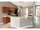 Open kitchen with stainless steel appliances and granite countertops flowing into the dining area at 1960 Fawn Meadow Cir, St Cloud, FL 34772