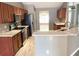 Well-equipped kitchen with stainless steel appliances, granite counters, and wooden cabinets at 1960 Fawn Meadow Cir, St Cloud, FL 34772