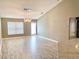 Open-concept living area featuring wood-look floors and modern light fixture at 1960 Fawn Meadow Cir, St Cloud, FL 34772