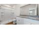 Bright bathroom featuring double granite vanity, white cabinets, and a shower at 2171 Longleaf Rd, Davenport, FL 33837