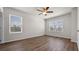 Spacious bedroom with wood-look floors, fan, and dual windows at 2171 Longleaf Rd, Davenport, FL 33837