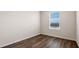 Bedroom with a large window offering natural light and wood-look flooring at 2171 Longleaf Rd, Davenport, FL 33837