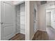 Hallway with walk-in pantry featuring wire shelving and white doors at 2171 Longleaf Rd, Davenport, FL 33837