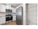 Stylish kitchen featuring stainless steel appliances and white cabinets, alongside a convenient pantry at 2171 Longleaf Rd, Davenport, FL 33837