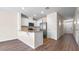 Modern kitchen with granite countertops, stainless steel appliances and sleek white cabinetry at 2171 Longleaf Rd, Davenport, FL 33837