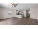 Open living space with ceiling fan connects to a modern kitchen with stainless steel appliances at 2171 Longleaf Rd, Davenport, FL 33837