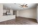 Bright, open-concept living room with wood floors, ceiling fan, and a breakfast bar overlooking the kitchen at 2171 Longleaf Rd, Davenport, FL 33837