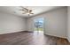 Sun-filled living room with wood-look flooring and sliding glass door to the backyard at 2171 Longleaf Rd, Davenport, FL 33837