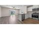 Bright living space blending seamlessly with a kitchen featuring stainless steel appliances at 2171 Longleaf Rd, Davenport, FL 33837