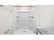 All-white shower stall next to toilet features built in shelves at 2171 Longleaf Rd, Davenport, FL 33837