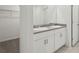 Bathroom with dual sinks, granite counters, and storage underneath, plus a walk-in closet at 2513 Merseyside Ct, Haines City, FL 33844