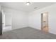 Spacious bedroom featuring neutral carpet, ensuite bath, and two entry doors at 2513 Merseyside Ct, Haines City, FL 33844