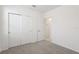Bedroom features neutral carpet, ample closet space, and an entry door at 2513 Merseyside Ct, Haines City, FL 33844