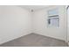 Small bedroom with neutral carpet and a large window providing natural light at 2513 Merseyside Ct, Haines City, FL 33844