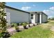 Exterior view featuring a tidy lawn and a brick paver walkway leading to a welcoming front entrance at 2513 Merseyside Ct, Haines City, FL 33844