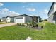 View of the house with a well-manicured lawn and a brick paver driveway leading to a spacious garage at 2513 Merseyside Ct, Haines City, FL 33844