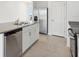 Kitchen island featuring a stainless steel dishwasher and a double sink at 2513 Merseyside Ct, Haines City, FL 33844