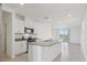 Bright kitchen featuring an island, stainless steel appliances, and sleek cabinetry at 2513 Merseyside Ct, Haines City, FL 33844