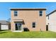 A well-maintained backyard with a grill and sliding glass door at 2634 Angel Falls Dr, Davenport, FL 33837