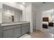 This bathroom features a double vanity and shower, as well as access to the main bedroom at 2634 Angel Falls Dr, Davenport, FL 33837