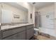 Bright bathroom featuring a granite countertop vanity and a shower with gray curtains at 2634 Angel Falls Dr, Davenport, FL 33837