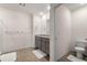 This bathroom has a double vanity with granite countertops and tile floors at 2634 Angel Falls Dr, Davenport, FL 33837