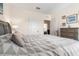 Bedroom with a gray upholstered bed featuring a decorative pillow, a side table, and neutral decor at 2634 Angel Falls Dr, Davenport, FL 33837