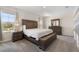 Spacious bedroom with neutral carpet, ample natural light, and dark wood bedroom set at 2634 Angel Falls Dr, Davenport, FL 33837