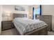 Bedroom with gray-toned furniture, a bright window, carpeted floors, and elegant decor at 2634 Angel Falls Dr, Davenport, FL 33837