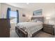 Comfortable bedroom with gray-toned furniture, bright window with blue curtains, and carpeted floors at 2634 Angel Falls Dr, Davenport, FL 33837