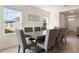 Dining area featuring a large table, seating for eight, and natural light from windows at 2634 Angel Falls Dr, Davenport, FL 33837