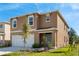 Charming home featuring a two-car garage, blue front door, and a well-manicured lawn at 2634 Angel Falls Dr, Davenport, FL 33837