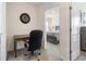 Home office featuring a desk, chair, and clock, visible from the doorway leading to the bedroom at 2634 Angel Falls Dr, Davenport, FL 33837
