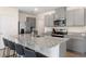 Modern kitchen featuring granite countertops, stainless steel appliances, and a large island with seating at 2634 Angel Falls Dr, Davenport, FL 33837