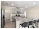 Modern kitchen featuring granite countertops, stainless steel appliances, and a large island with seating at 2634 Angel Falls Dr, Davenport, FL 33837