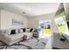 Comfortable living room area with a large sectional sofa and sliding glass doors at 2634 Angel Falls Dr, Davenport, FL 33837