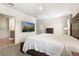 This main bedroom features a TV, dresser, carpeted floors, and an attached bathroom at 2634 Angel Falls Dr, Davenport, FL 33837