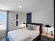 Cozy bedroom with decorative wall, bedside tables with lamps, and a comfortable looking bed at 2688 Gouda Dr, Apopka, FL 32703