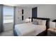 Comfortable bedroom featuring stylish wall accents, soft lighting, and a window with a view at 2688 Gouda Dr, Apopka, FL 32703