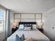 Bright bedroom featuring a decorative headboard and lots of natural light from a window at 2688 Gouda Dr, Apopka, FL 32703