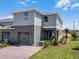 Two-story home with a two-car garage, inviting front yard, and a cozy covered patio at 2688 Gouda Dr, Apopka, FL 32703